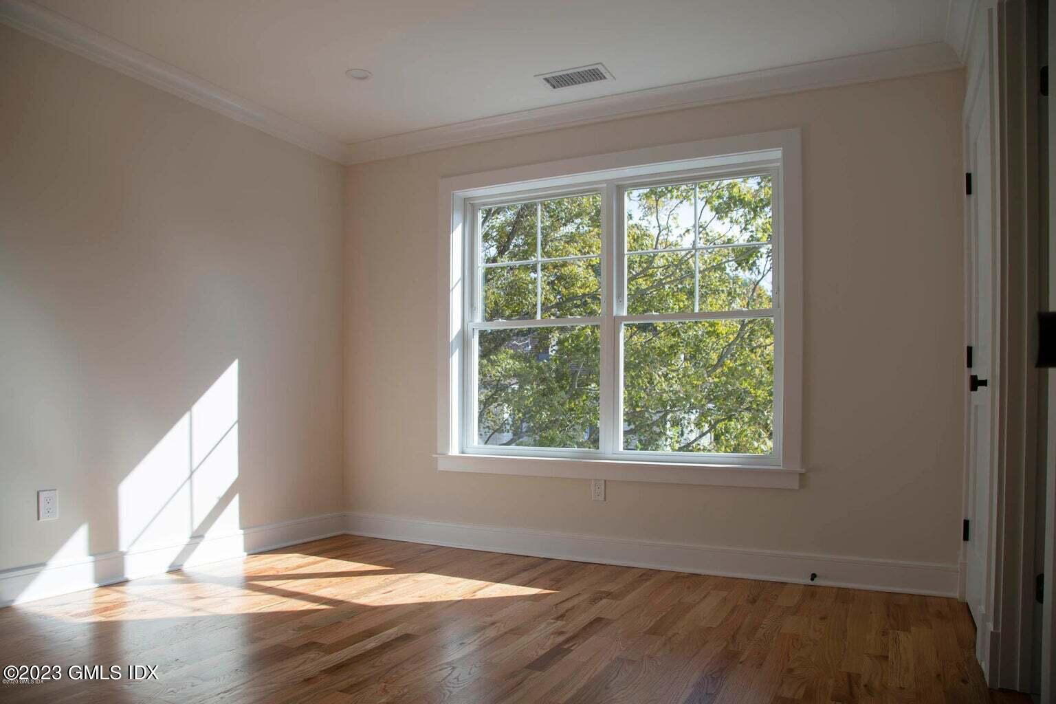 292 Delavan Avenue, Unit 2 Greenwich, CT 06830 - Photo 10 of 22 a view of empty room with wooden floor and fan