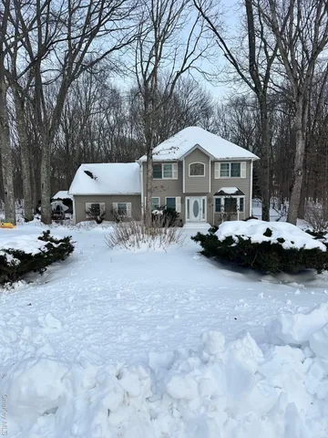 a view of a patio with a table and chairs under an umbrella