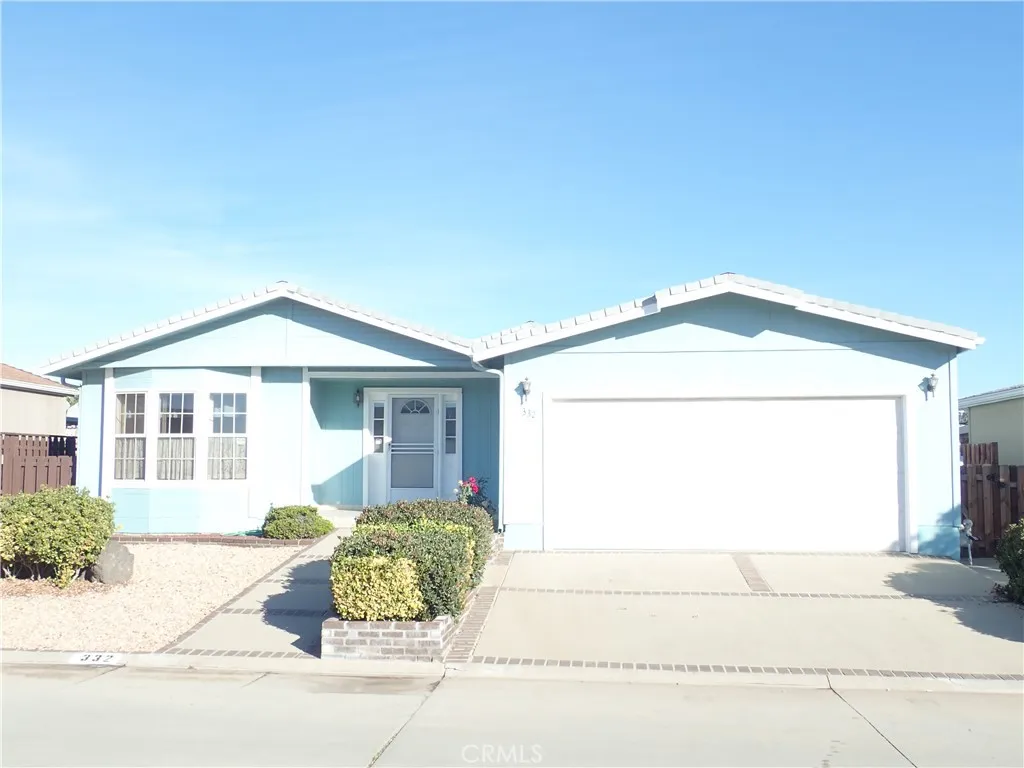 27250 Murrieta Road, Unit 332 Menifee, CA 92586 - Photo 2 of 26 a front view of a house with a yard and garage