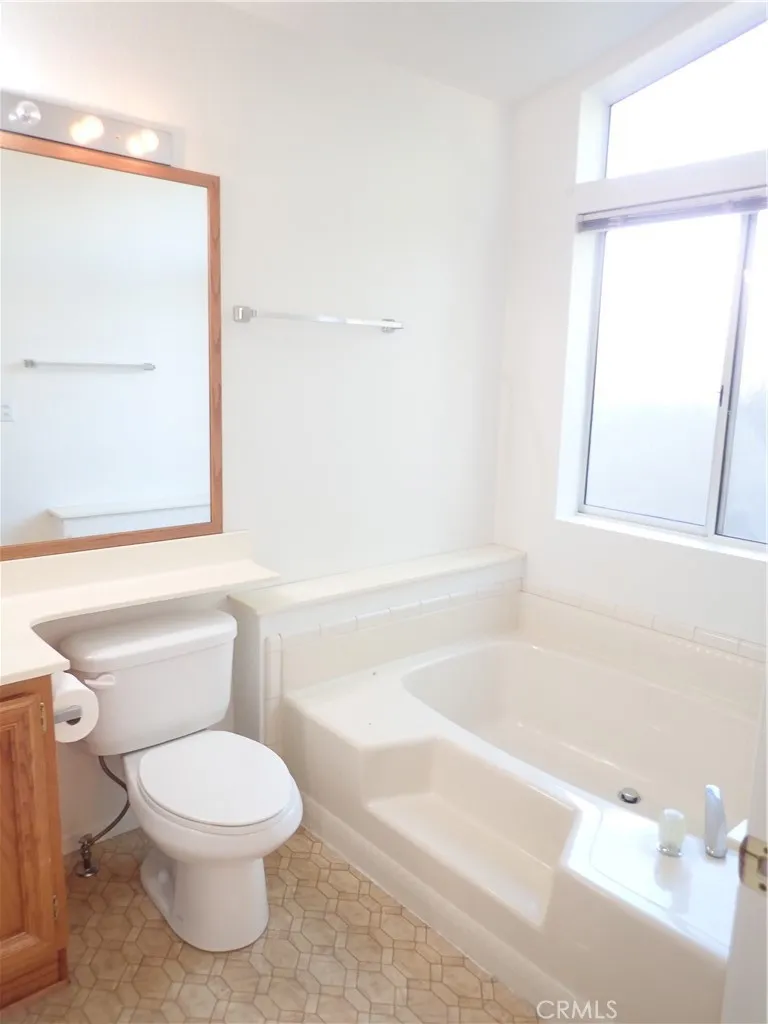 27250 Murrieta Road, Unit 332 Menifee, CA 92586 - Photo 21 of 26 a bathroom with a toilet a sink and a bathtub
