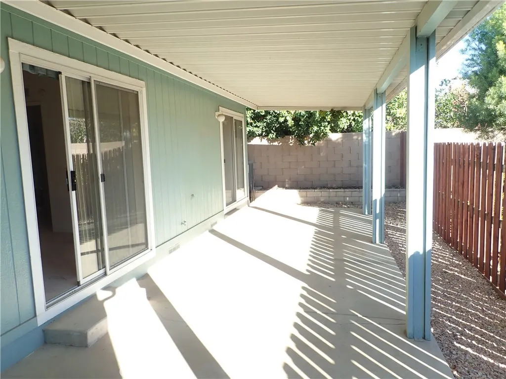 27250 Murrieta Road, Unit 332 Menifee, CA 92586 - Photo 23 of 26 a bedroom with a bed wooden floor and a large window