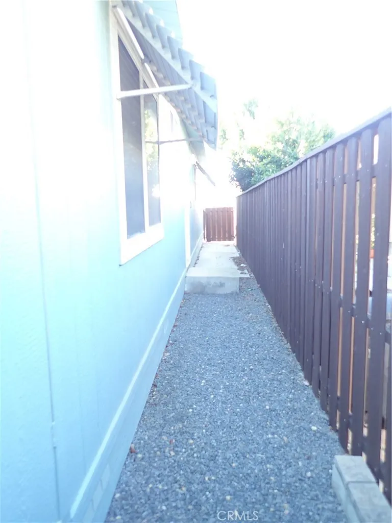 27250 Murrieta Road, Unit 332 Menifee, CA 92586 - Photo 26 of 26 a view of a backyard with wooden fence and large windows