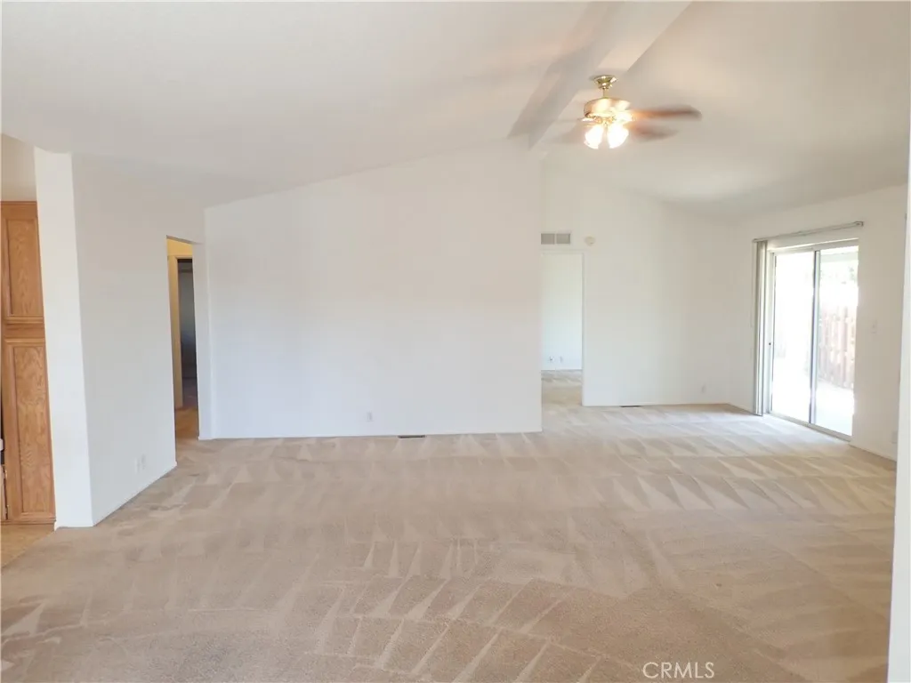27250 Murrieta Road, Unit 332 Menifee, CA 92586 - Photo 5 of 26 a view of an empty room with a chandelier fan