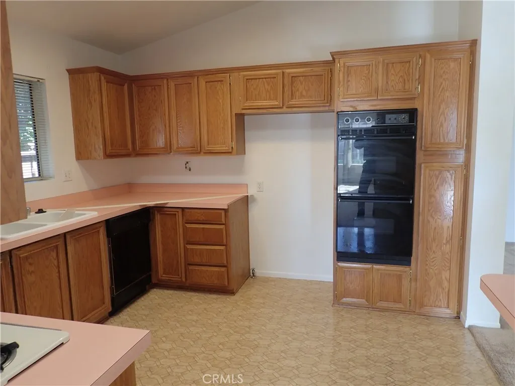 27250 Murrieta Road, Unit 332 Menifee, CA 92586 - Photo 9 of 26 a kitchen with a cabinets and a stove top oven