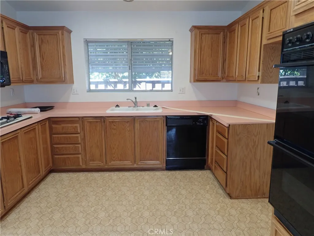 27250 Murrieta Road, Unit 332 Menifee, CA 92586 - Photo 10 of 26 a kitchen with a sink stove and cabinets