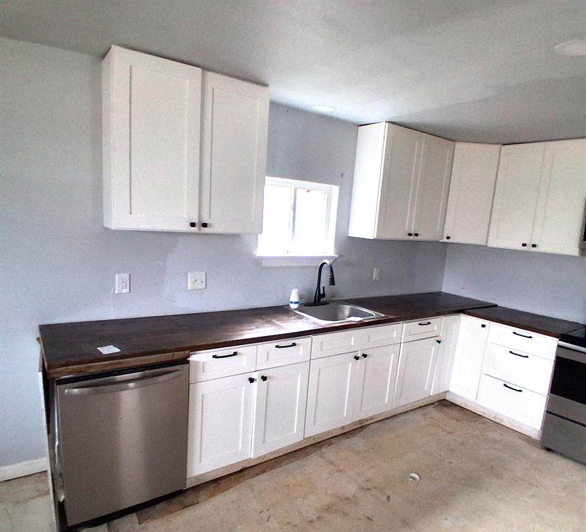 7019 Darling Street Azle, TX 76020 - Photo 7 of 19 a kitchen with granite countertop white cabinets and sink