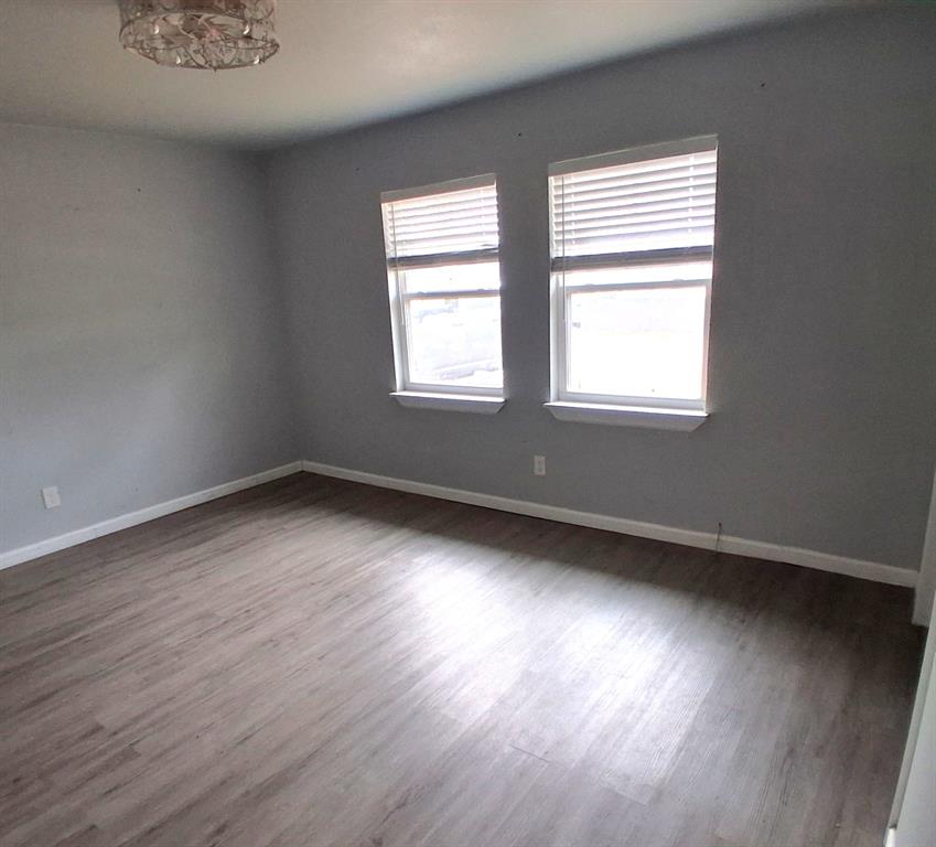 7019 Darling Street Azle, TX 76020 - Photo 10 of 19 an empty room with wooden floor and windows