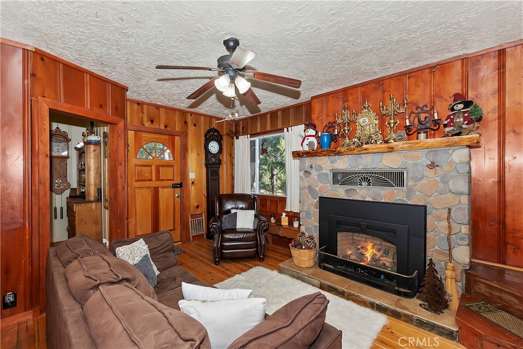 29591 Hook Creek Road Cedar Glen, CA 92321 - Photo 2 of 43 a living room with furniture a fireplace and a flat screen tv