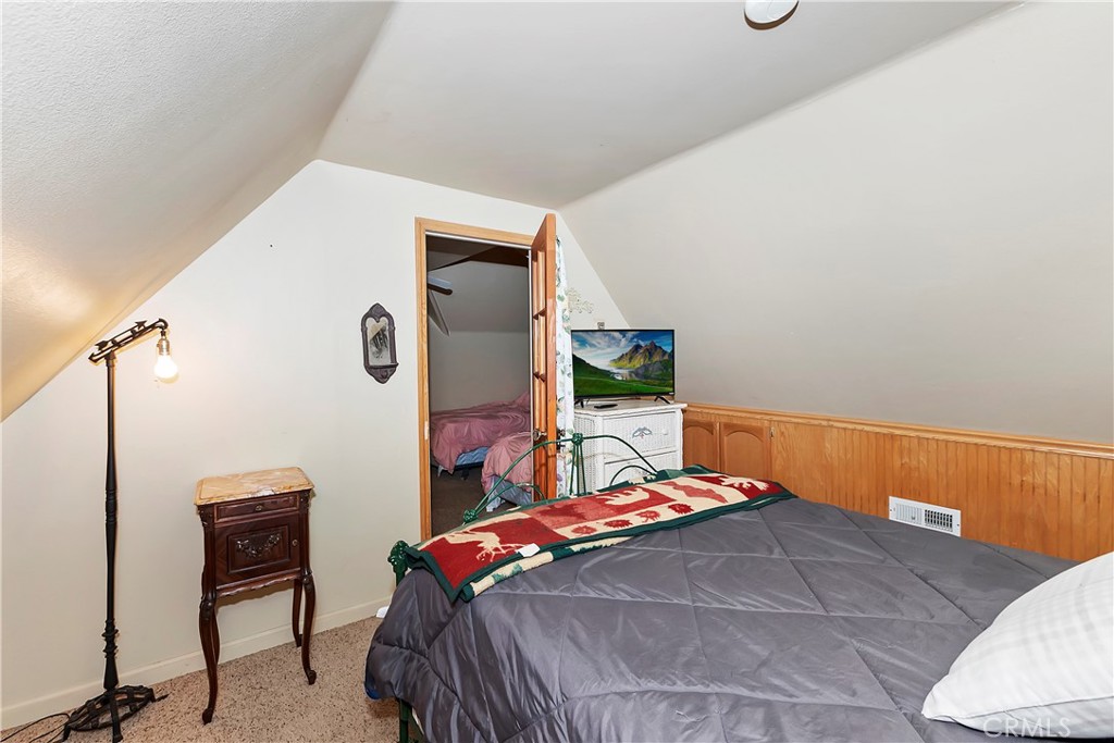 29591 Hook Creek Road Cedar Glen, CA 92321 - Photo 26 of 43 a bedroom with a bed and a table in it