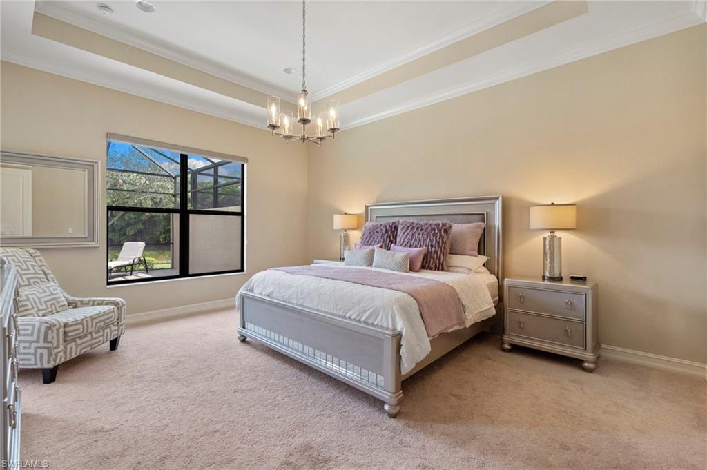 6564 Roma Way Naples, FL 34113 - Photo 12 of 18 a spacious bedroom with a bed couch and window