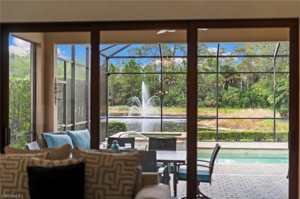 6564 Roma Way Naples, FL 34113 - Photo 15 of 18 a living room with furniture and a floor to ceiling window