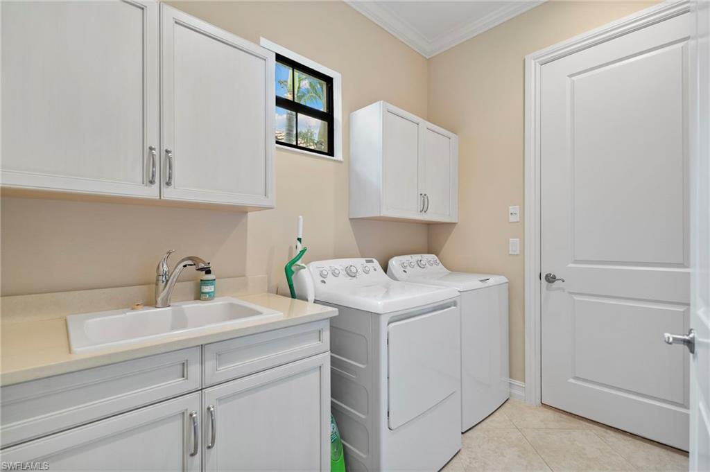 6564 Roma Way Naples, FL 34113 - Photo 16 of 18 a view of storage and utility room with washer and dryer