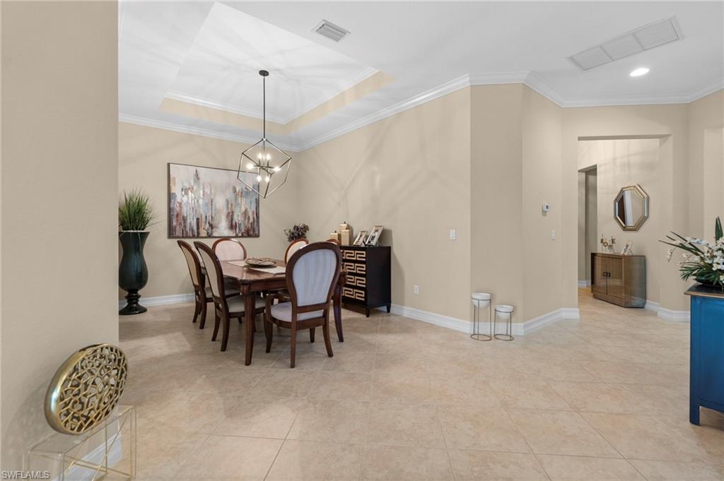 6564 Roma Way Naples, FL 34113 - Photo 3 of 18 a view of a dining room with furniture and chandelier