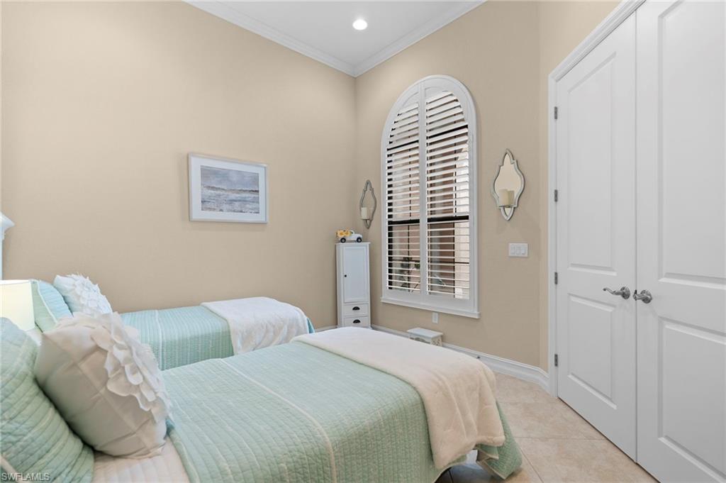 6564 Roma Way Naples, FL 34113 - Photo 9 of 18 a bedroom with a bed and a painting on the wall
