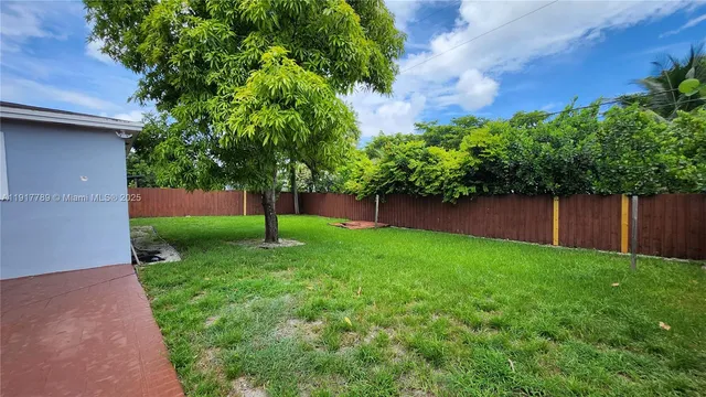 a view of a backyard with a small cabin