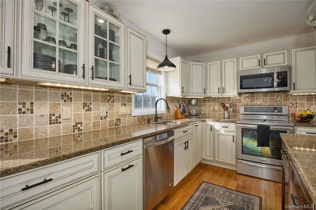 a kitchen with a sink stove and microwave