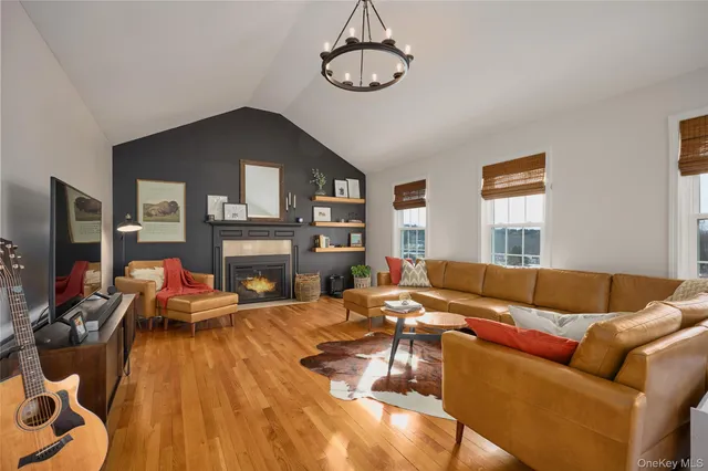 a living room with furniture fireplace and flat screen tv