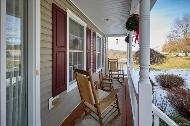 a balcony with table and chairs