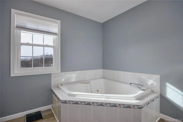 a white bath tub sitting in a bathroom