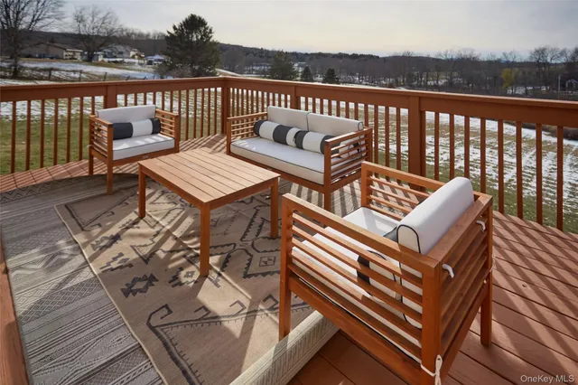 a roof deck with a couch and wooden floor