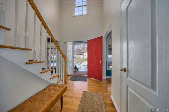 a view of an entryway with wooden floor and stairs