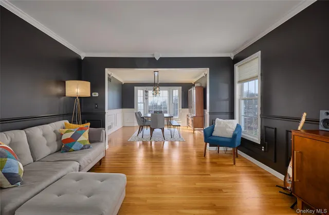 a living room with furniture and a chandelier