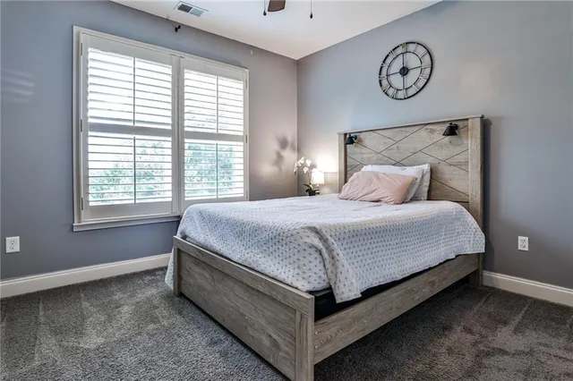 a bed sitting in a bedroom next to a window