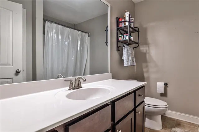 a bathroom with a sink vanity and toilet