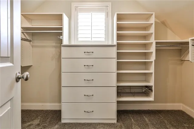 a view of walk in closet with empty racks
