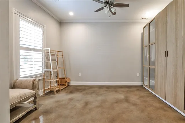 a view of room with a ceiling fan and window