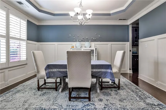 a view of a dining room with furniture and a chandelier