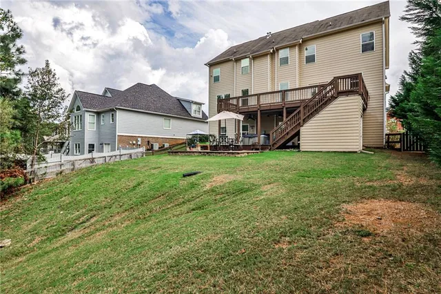 a view of a house with a yard and sitting area