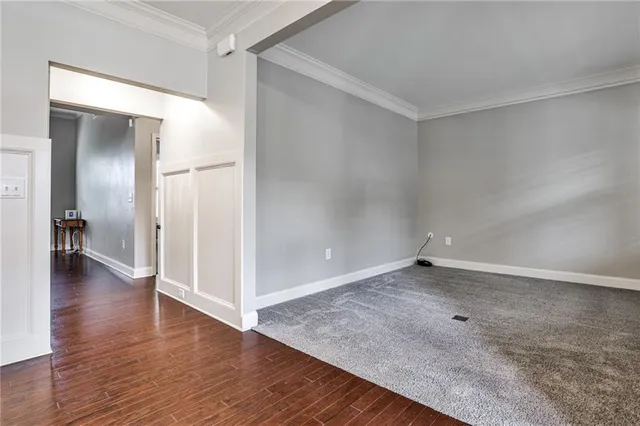 a view of a room with wooden floor