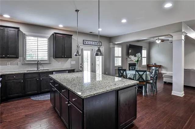 a kitchen with center island table and chairs