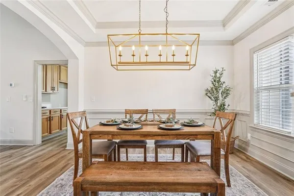 a kitchen with a sink cabinets and a wooden floor