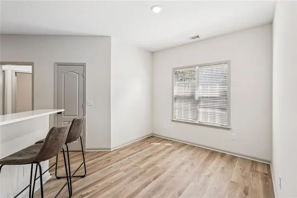 a kitchen with a refrigerator and cabinets