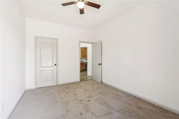 a front view of a house with a large window and plants