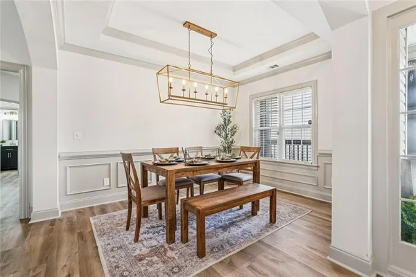 a bathroom with a granite countertop bathtub a double vanity sink and mirror