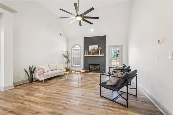 a living room with furniture a dining table and wooden floor