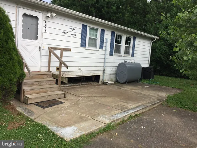 a view of a house with a backyard and a patio