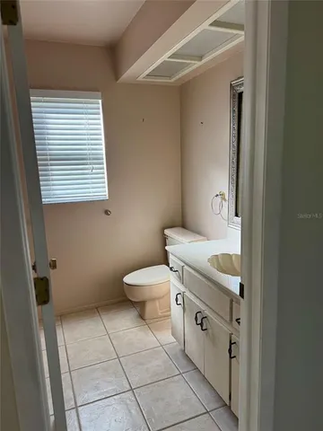 a bathroom with a toilet a sink and a mirror
