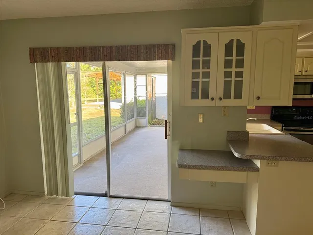 a kitchen with a refrigerator and window