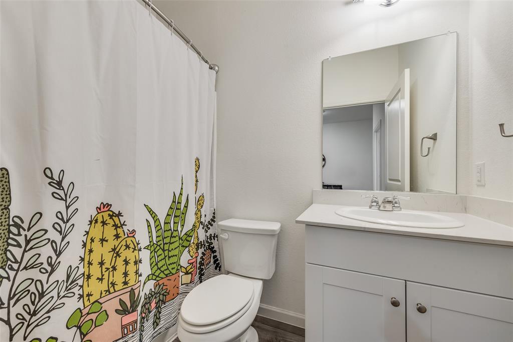 2544 Sanders Crk Road Glenn Heights, TX 75154 - Photo 16 of 20 a bathroom with a sink a toilet and a mirror