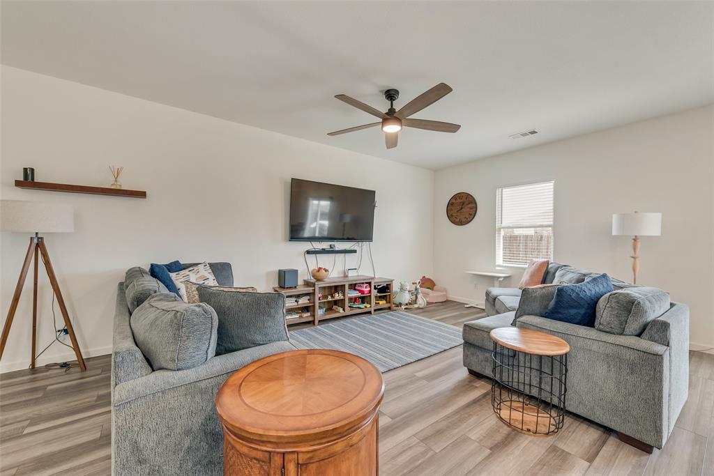 2544 Sanders Crk Road Glenn Heights, TX 75154 - Photo 5 of 20 a living room with furniture a ceiling fan and a flat screen tv