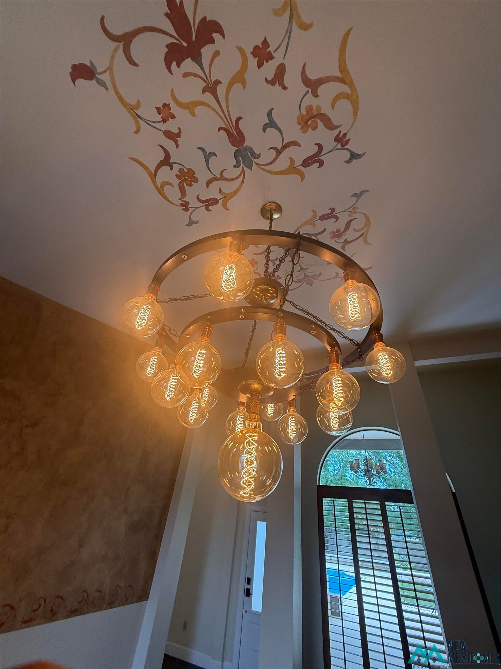 1111 West Country Road Roswell, NM 88201 - Photo 7 of 41 Ornate ceiling mural with a multi-tiered chandelier featuring exposed filament bulbs