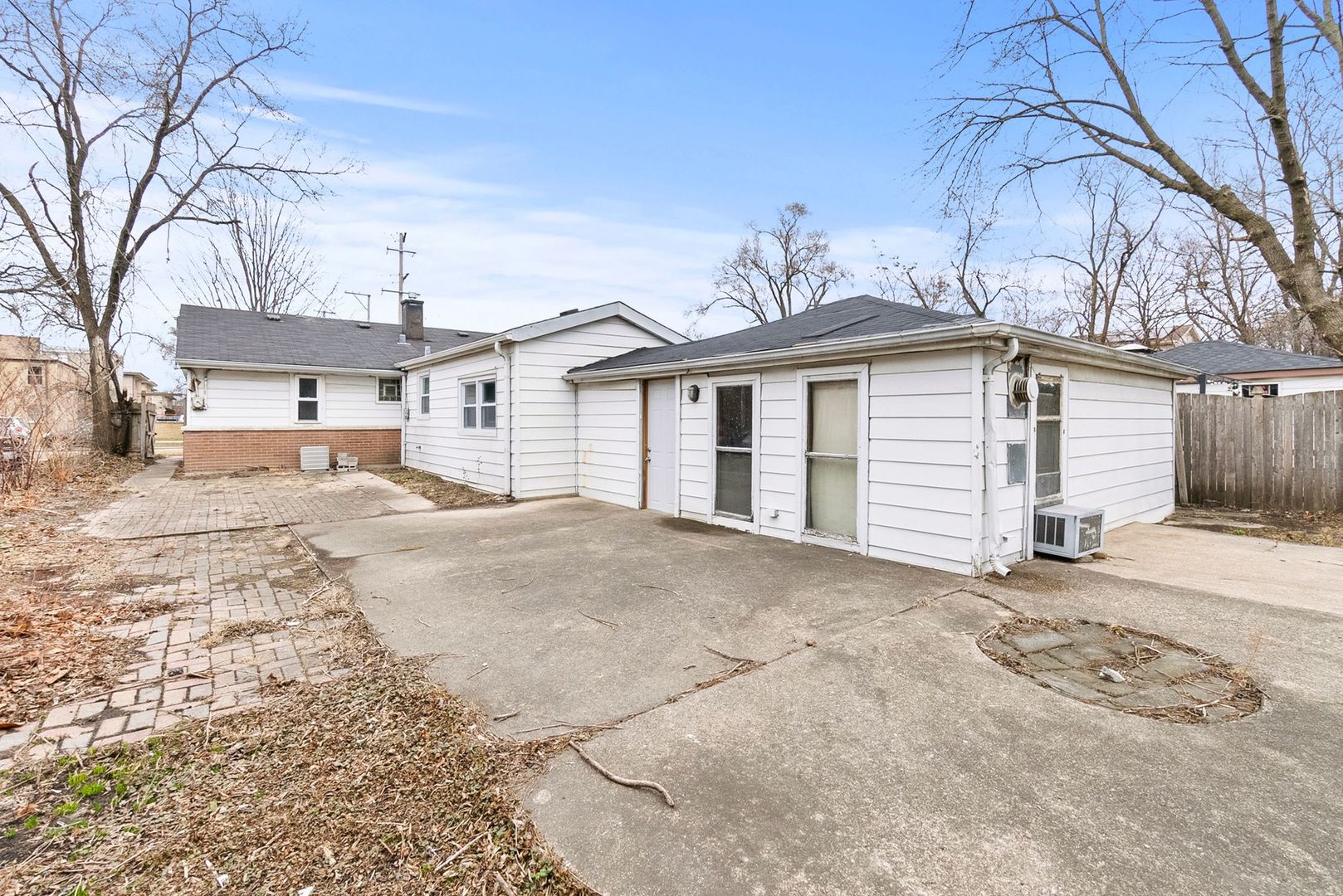7911 45th Street Lyons, IL 60534 - Photo 18 of 22 a view of a white house with a large tree and a yard