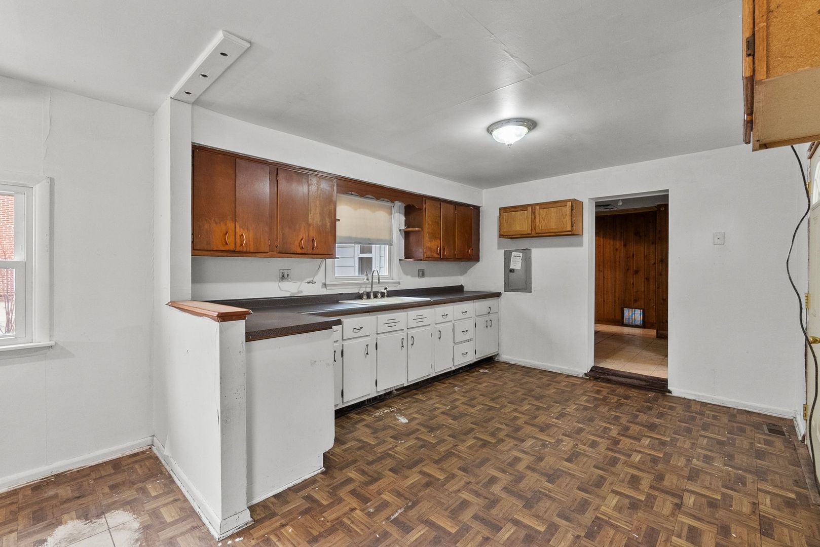 7911 45th Street Lyons, IL 60534 - Photo 7 of 22 a large kitchen with kitchen island granite countertop a refrigerator and a stove top oven
