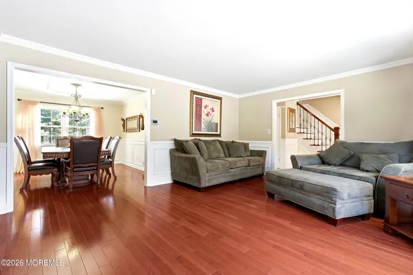 a kitchen with stainless steel appliances granite countertop a stove top oven a sink a dining table and chairs