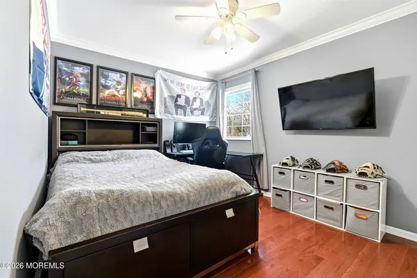 a room with furniture pool table wooden floor and windows