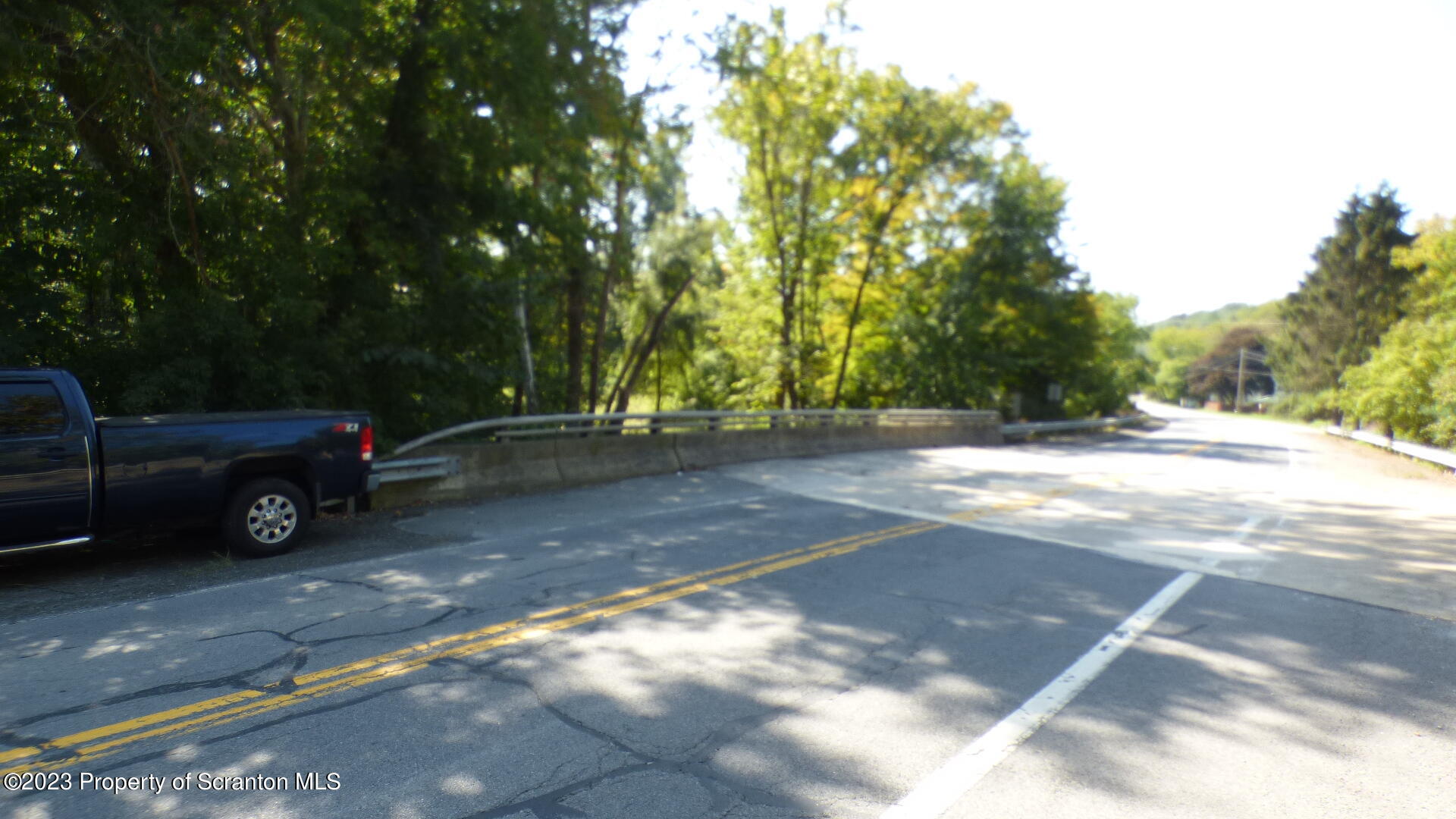 92 State Route Nicholson, PA 18446 - Photo 5 of 7 a view of a yard with car parked